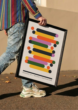 Bauhaus Stacks by Neil Stevens carried in a black frame along a sunny street