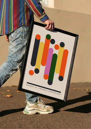 Bauhaus Columns by Neil Stevens carried in a black frame along a sunny street