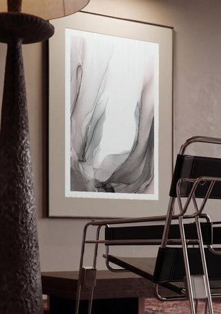 Traces of Wind by Anna Dormir framed in a dim room beside a tubular steel chair