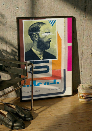 Beard by Kareem Rizk in a black frame leaning against a concrete wall by a steel chair