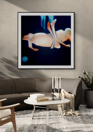 Contact #2 by Luis Valquaresma in a black frame on a grey wall above a dark sofa with candlesticks
