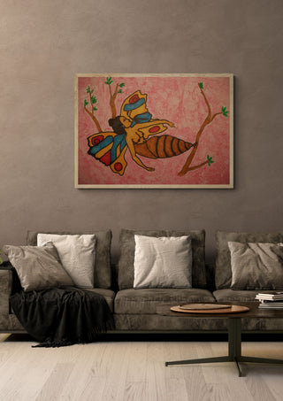 EGO fallenlassen by Olaf Baier in a pale wooden frame above a grey sofa with cushions