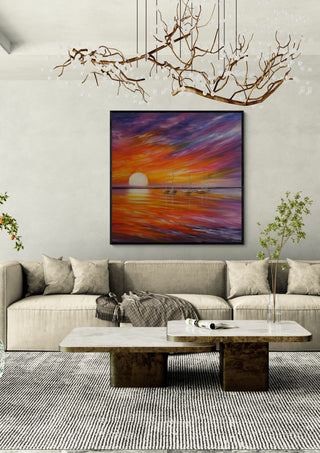 Colorful by Sunny in a black frame above a beige sofa under a branch chandelier