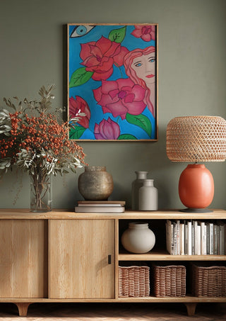 The watching Eye by Carmen Coduri above a wooden sideboard on a sage green wall