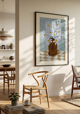 Rutig duk med brun vas by Rebecka Hansson in a black frame in a bright dining room with wooden chairs