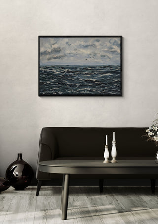 Beyond the storm by Maya in a black frame above a dark sofa with candlesticks