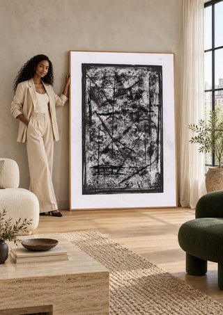 Black Field by David Pernecker in a tall wooden frame leaning against a wall in a sunlit room