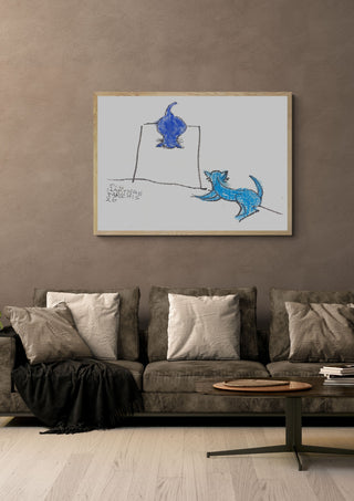 Two Blue Cats by Eva Hartman in a pale wooden frame above a grey sofa with cushions