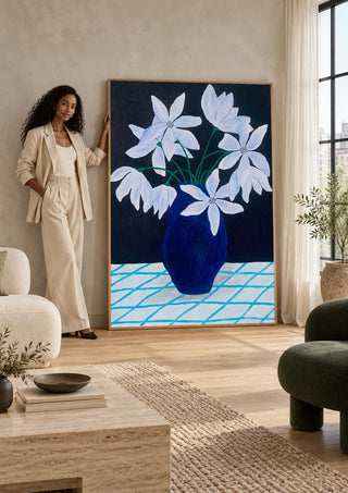 Blå blomster på rutig duk by Rebecka Hansson in a tall wooden frame leaning against a wall in a sunlit room