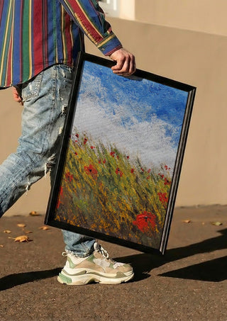 Coquelicots by GAHO carried in a black frame along a sunny street