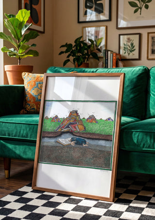 The Reading Mole by Waldemar Mandzel in a wooden frame leaning against a green velvet sofa on a chequered floor