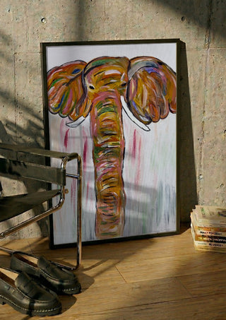 Chromatic Matriarch by Bibi in a black frame leaning against a concrete wall by a steel chair