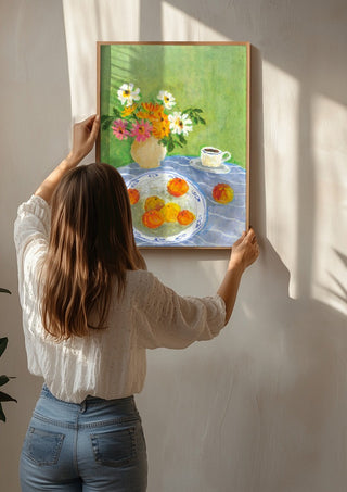 February Zinnias by Deblina Dey being hung on a sunlit wall