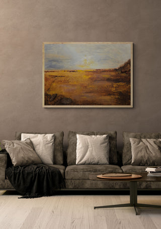 When the Light Grows Quiet by Sabine Halbrock in an oak frame above a grey sofa with cushions