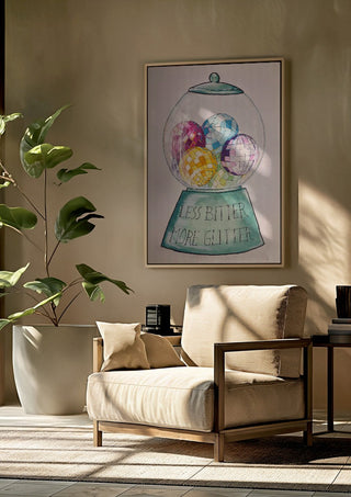 Less Bitter More Glitter by L.OE. Art framed above a beige armchair beside a potted plant