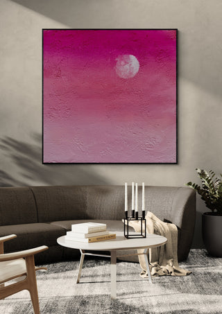 Pink Atmosphere by Marina Agre in a black frame above a grey sofa with candlesticks