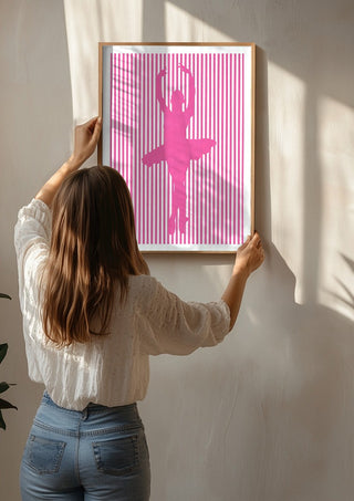 Ballerina silhouette by nyai being hung on a sunlit wall