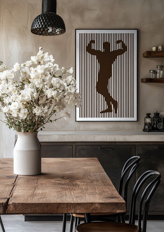 bodybuilder silhouette by nyai in a black frame above a rustic table with white flowers