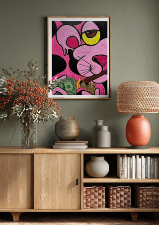 Capitalist Illusion by Bibi above a wooden sideboard on a sage green wall