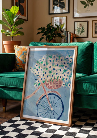 Whimsical Journey in White by Bibi in a wooden frame beside a green velvet sofa on a chequered floor
