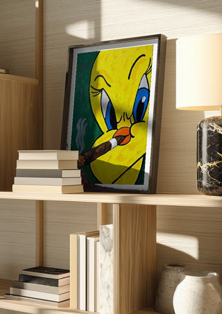 Bad Birdie by Bibi in a dark frame on a wooden shelf beside books and a lamp