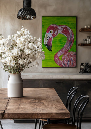 Vibrant Flamingo by Bibi in a black frame above a rustic table with white flowers