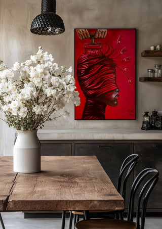 TNT by Ronny Simon in a black frame above a rustic table with white flowers
