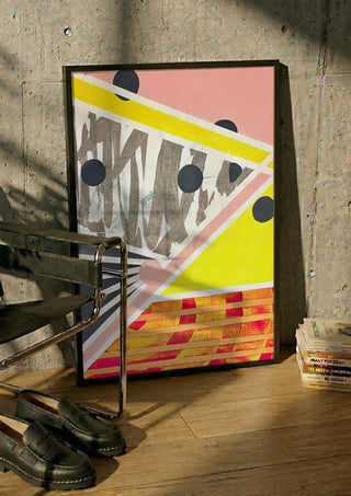 A favourite crossing by Vanyay in a black frame leaning against a concrete wall by a steel chair