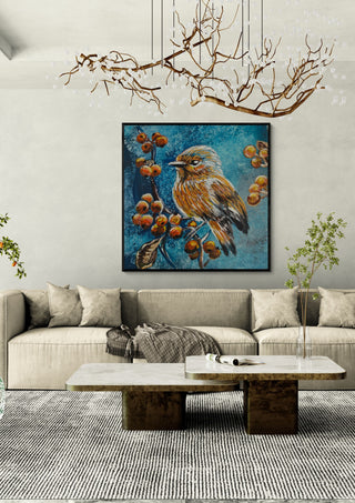 Bird on the autumn tree by Svetla Stoyanova Bassi in a black frame above a beige sofa under a branch chandelier