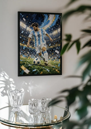 Lionel Messi by Danii Steinfeldt in a black frame above a glass table with crystal glassware