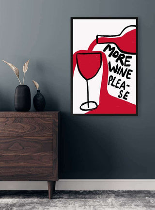 Framed wall art with a red wine bottle pouring into a glass, text reads "More Wine Please."