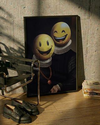 Framed artwork of two figures in vintage attire with large smiley face heads, displayed next to books and shoes.