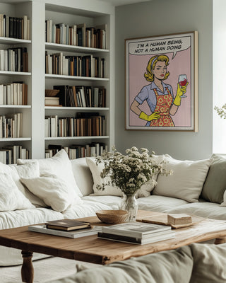 Human Being Pop Art by Andreas Magnusson on wall above sofa in cozy, modern living room with bookshelves.