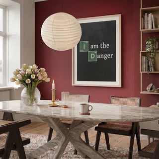 Dining room with Science Danger Message - HUGO art on red wall, marble table, chairs, flowers, and candle.