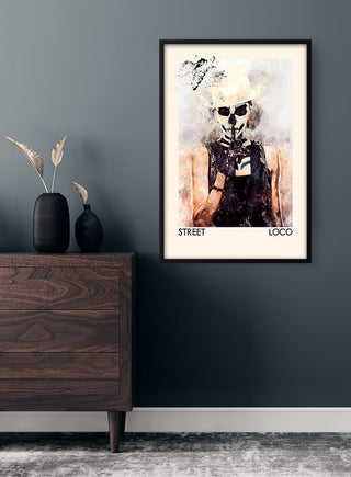 Framed Street Art Loco Plakat featuring a stylized figure on a dark wall above a wooden dresser.