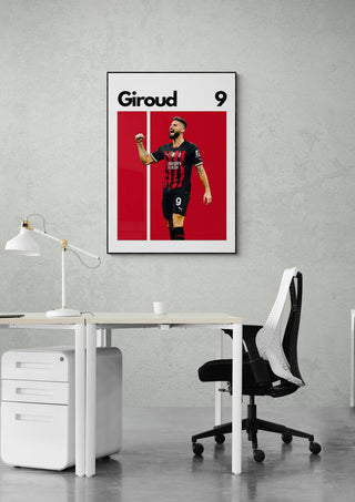 Oliver Giroud football poster featuring him in a black and red kit, displayed on an office wall above a desk.