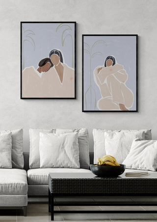 Framed "Girlfriends - Ivy Green" art prints hanging above a modern sofa with neutral cushions and a bowl of bananas.