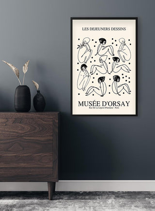 Minimalist line art poster of abstract nude women, inspired by Picasso, hanging on a dark wall above a dresser.