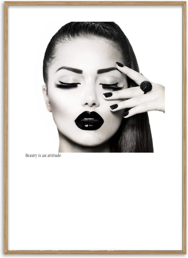Black and white poster of a woman with bold makeup, dark lips, and the text "Beauty is an attitude."