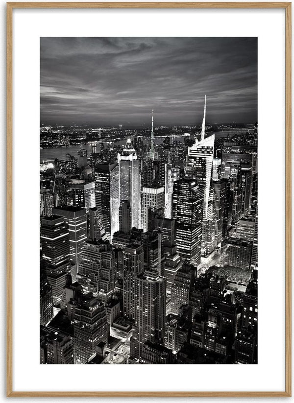 Black and white poster of New York City skyline with illuminated skyscrapers at night.