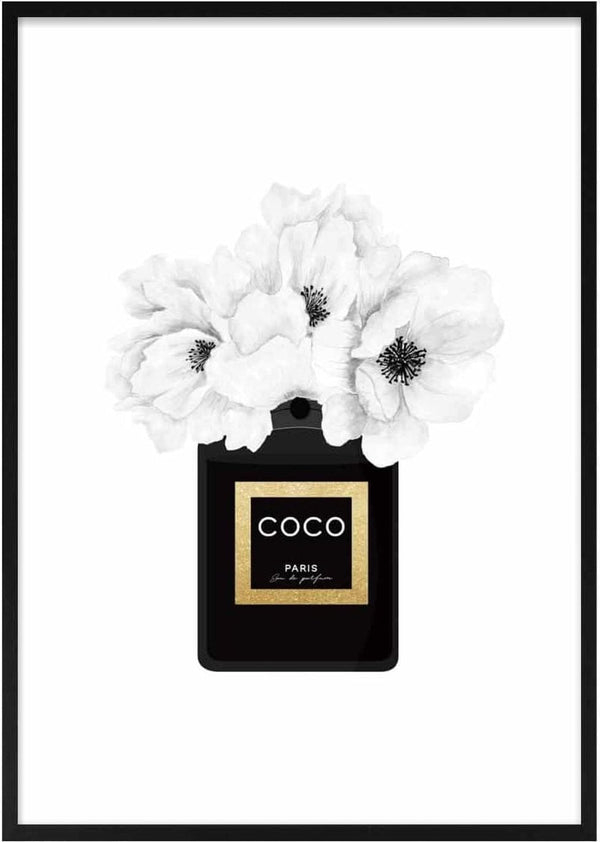 Black Chanel perfume bottle with white flowers blooming from the top, Coco Paris label in gold and black.