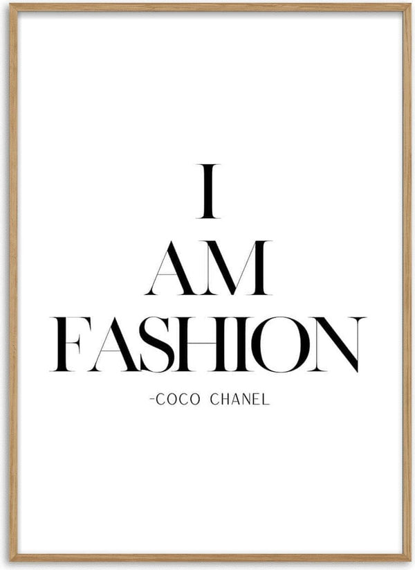 Minimalist poster with the text "I AM FASHION -COCO CHANEL" in elegant black lettering on a white background.