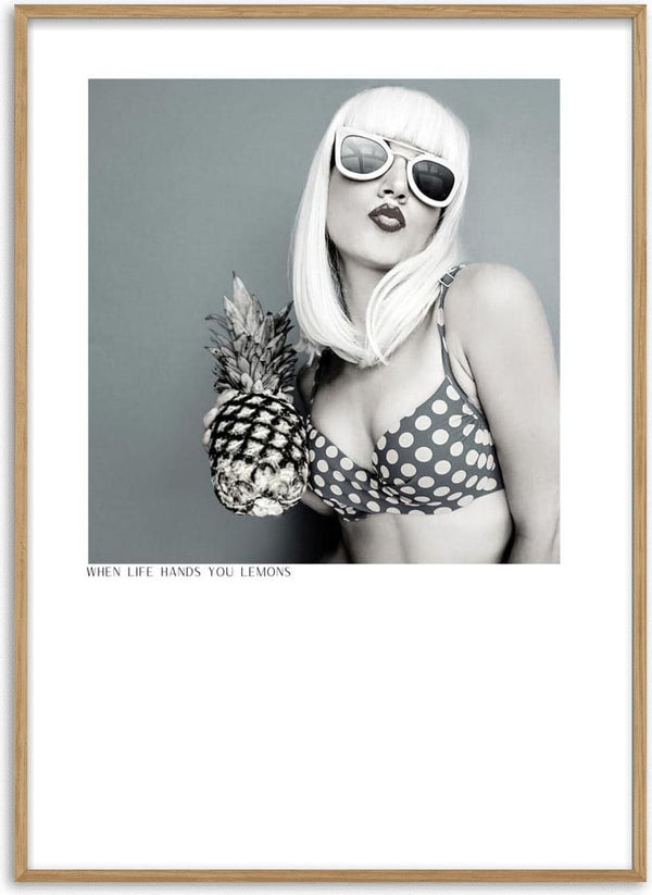 Woman in polka dot bikini holding pineapple, wearing sunglasses; "When life hands you lemons" poster.